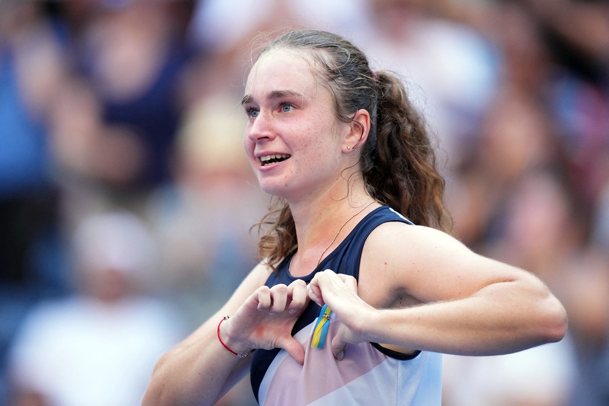 Ukraine's Daria Snigur makes a heart over a pin with the colours of Ukraine as she celebrates victory over Romania's Simona Halep on Monday, Day 1 of the 2022 US Open, at Billie Jean King National Tennis Center.