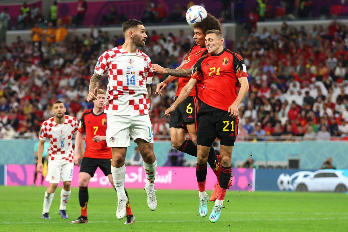 Marko Livaja of Croatia jumps for the ball with Axel Witsel and Timothy Castagne of Belgium