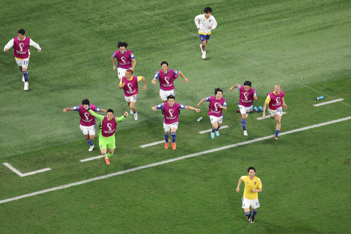 Japan's players and staff are ecstatic after their 2-1 win over Spain on Thursday