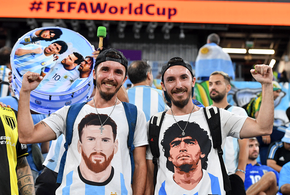 Argentina fans wearing T-shirts depicting Argentina's Lionel Messi and Diego Maradona inside the stadium before the match between Argentina and Poland on Wednesday 