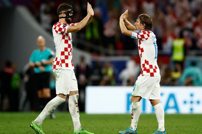 Croatia's Luka Modric and Josko Gvardiol celebrate after the match as Croatia qualify for the knockout stages