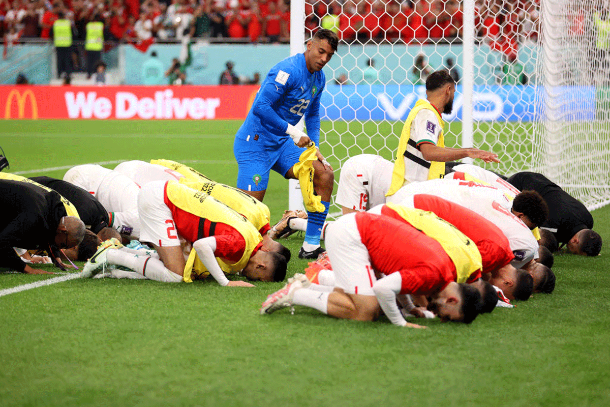 Morocco players celebrate after the team's qualification to the knockout stages