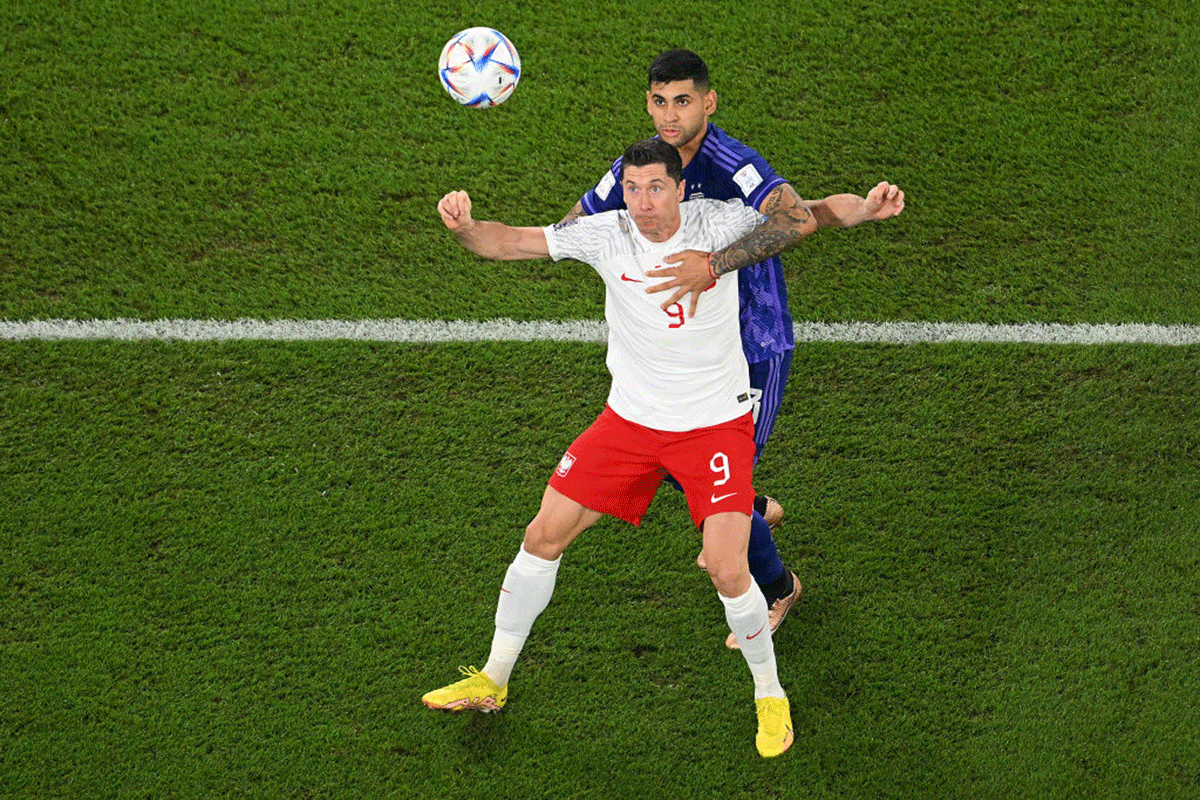 Poland's Robert Lewandowski battles for possession with Argentina's Cristian Romero