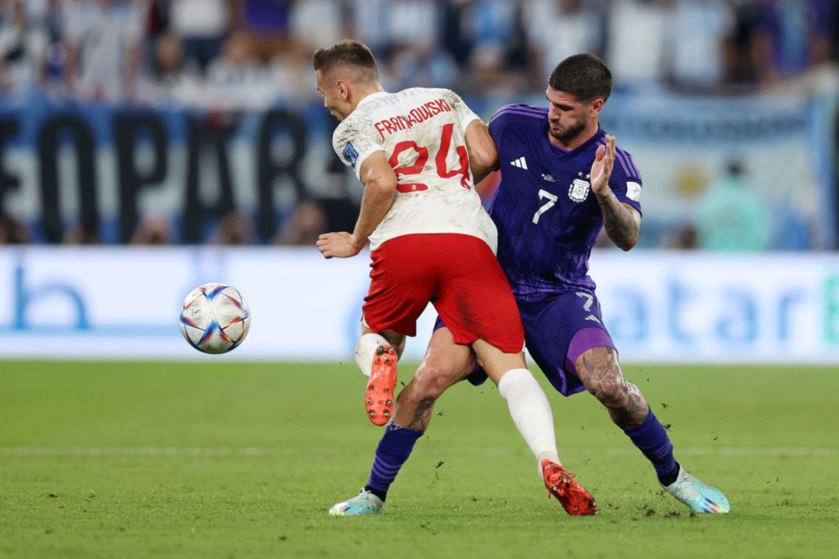 Poland's Przemyslaw Frankowski is challenged by Argentina's Rodrigo De Paul