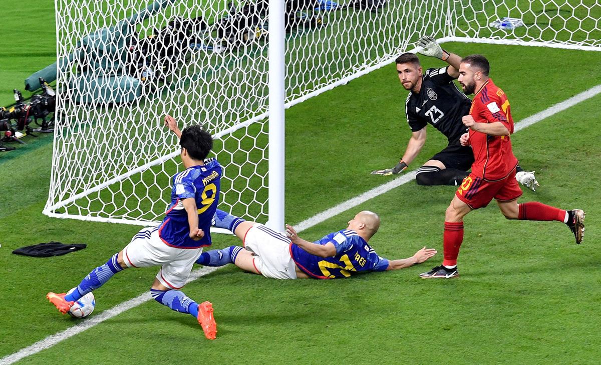 Japan's Kaoru Mitoma in action as the ball appears to cross the line before Japan's Ao Tanaka scores their second goal