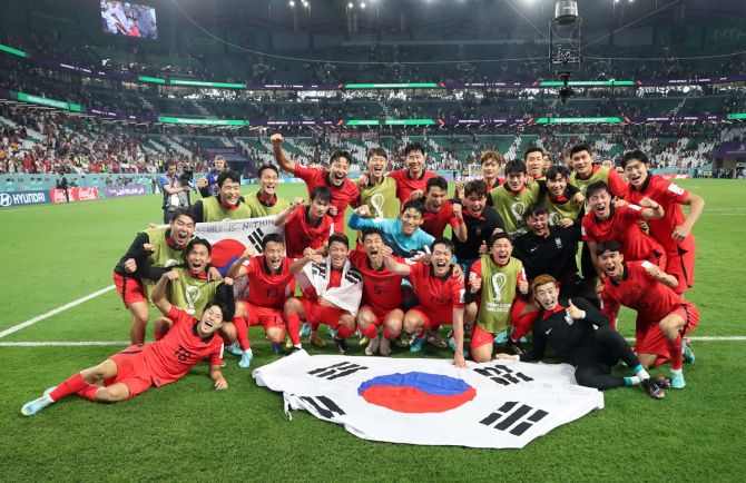 South Korea's players celebrate victory over Portugal in the World Cup Group H match and clinching a place in the last 16 of the tournament in Qatar.