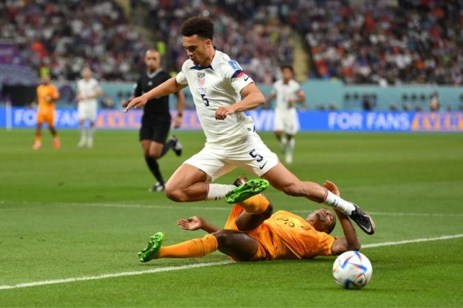 Antonee Robinson of United States is challenged by Denzel Dumfries of Netherlands