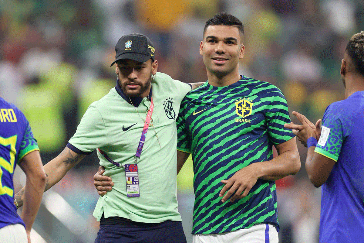 Brazil's Neymar and Casemiro celebrate after the team's qualification to the knockout stages of the FIFA World Cup Qatar 2022