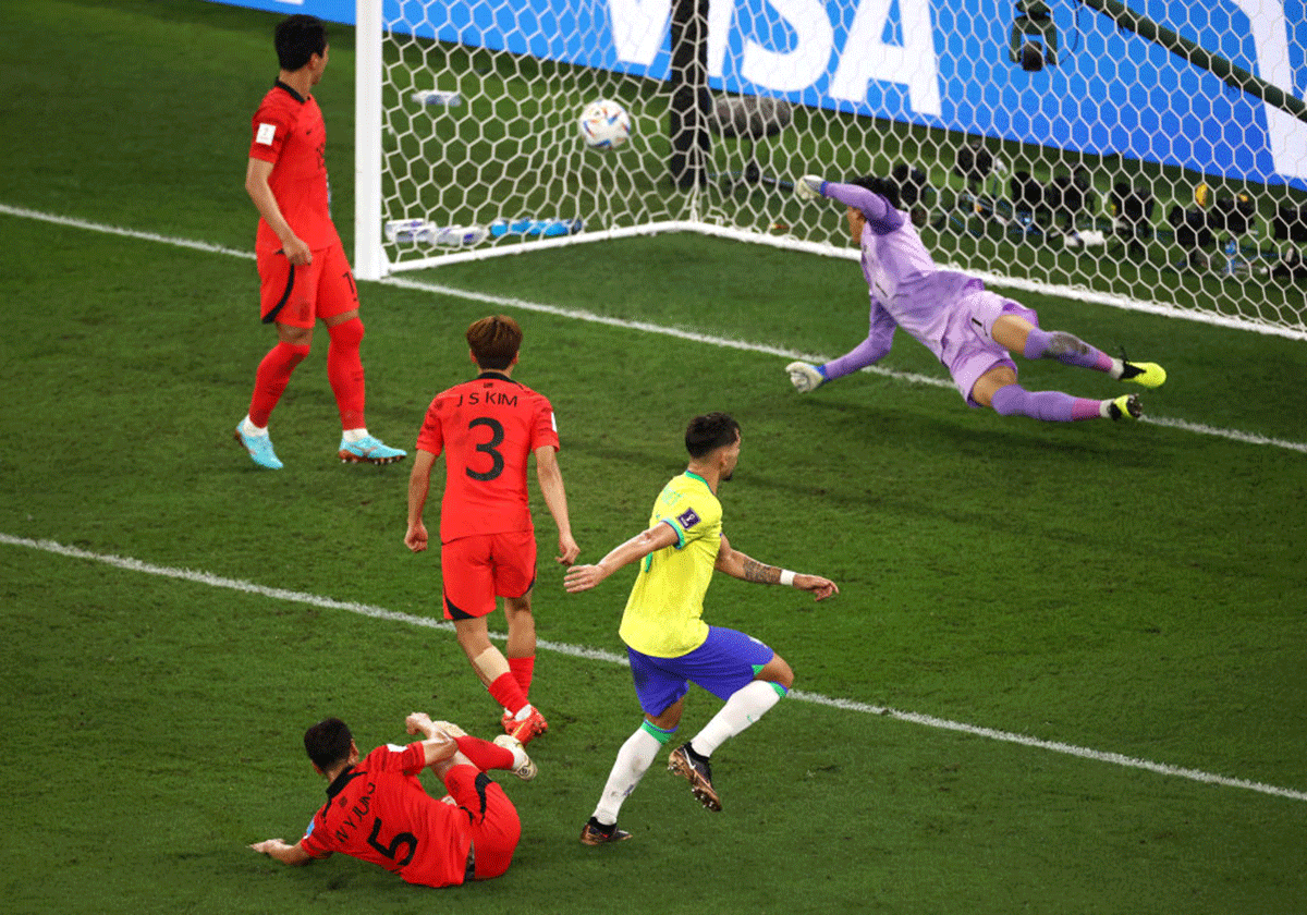 Brazil's Lucas Paqueta scores the fourth goal, beating the deperate dive of the South Korean keeper