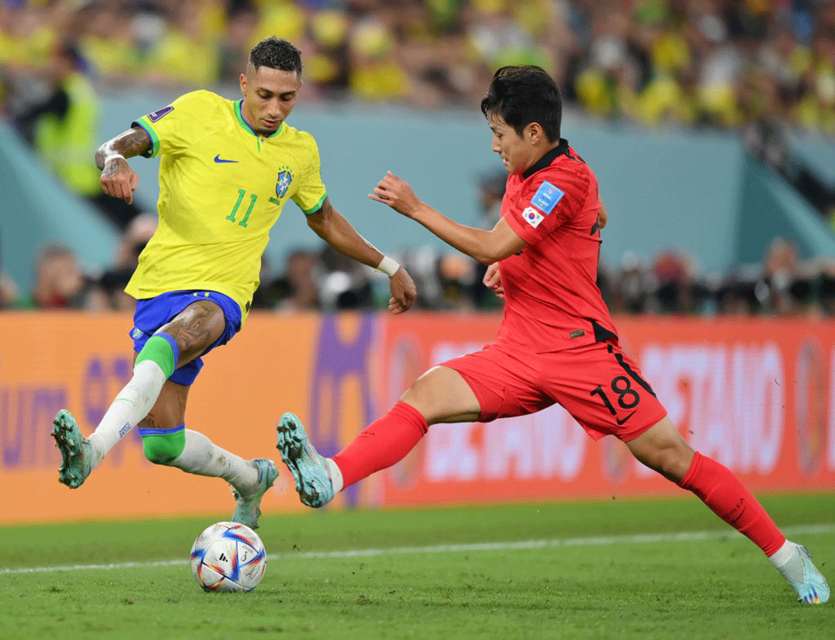 Brazil's Raphinha battles for possession with South Korea's Kangin Lee