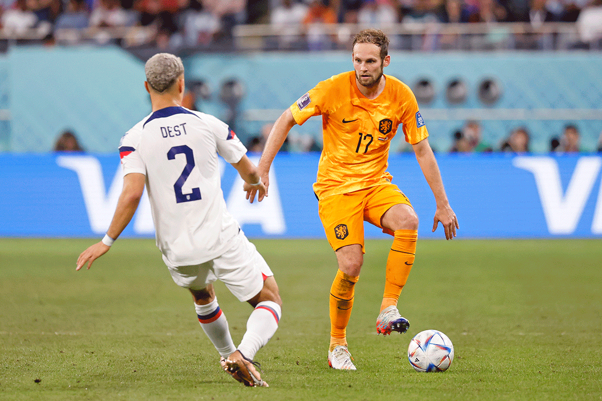 Netherlands defender Daley Blind (17) vies with United States of America defender Sergino Dest (2) during the second half of a round of sixteen match in the 2022 FIFA World Cup at Khalifa International Stadium on December 3