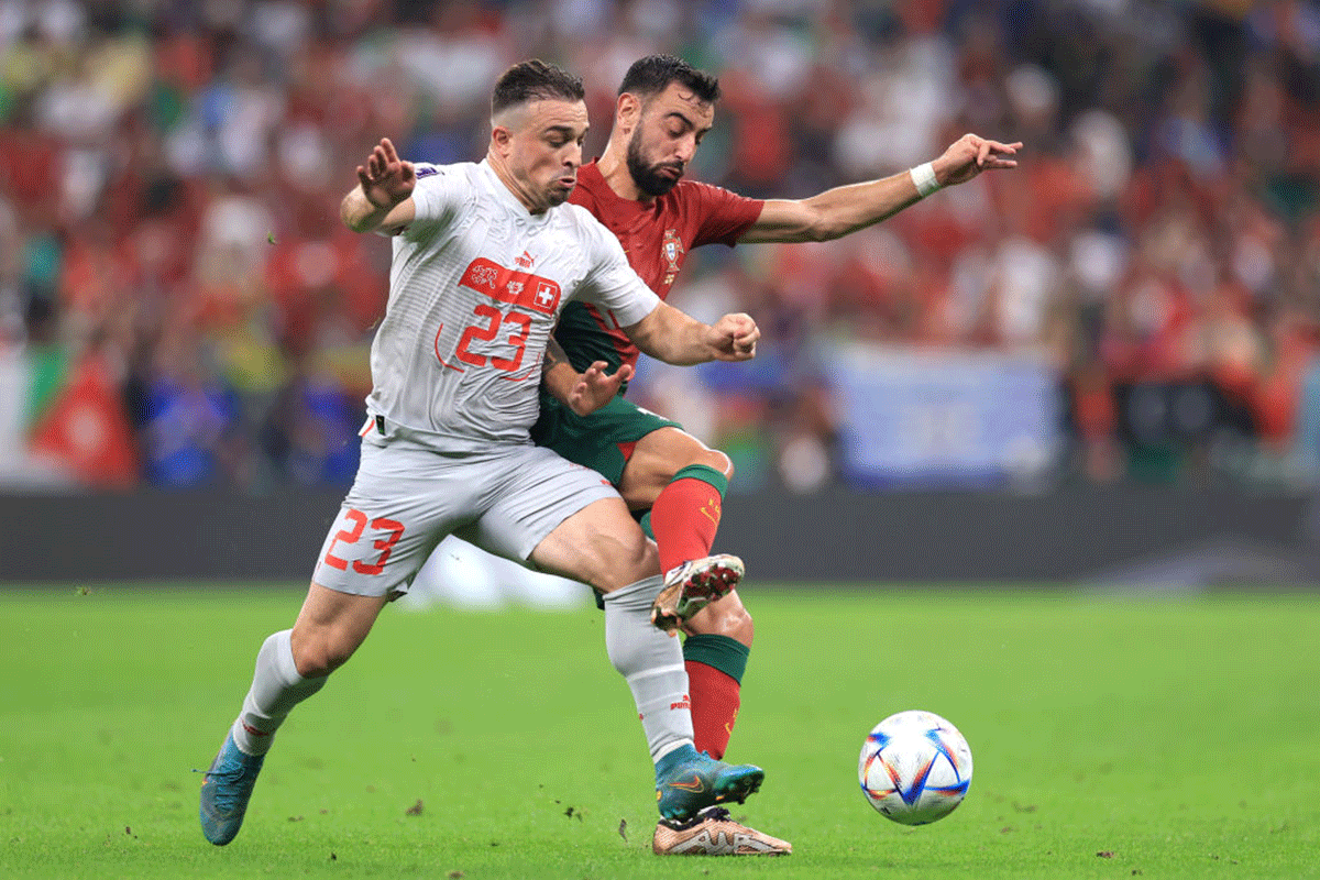 Switzerland's Xherdan Shaqiri is challenged by Portugal's Bruno Fernandes