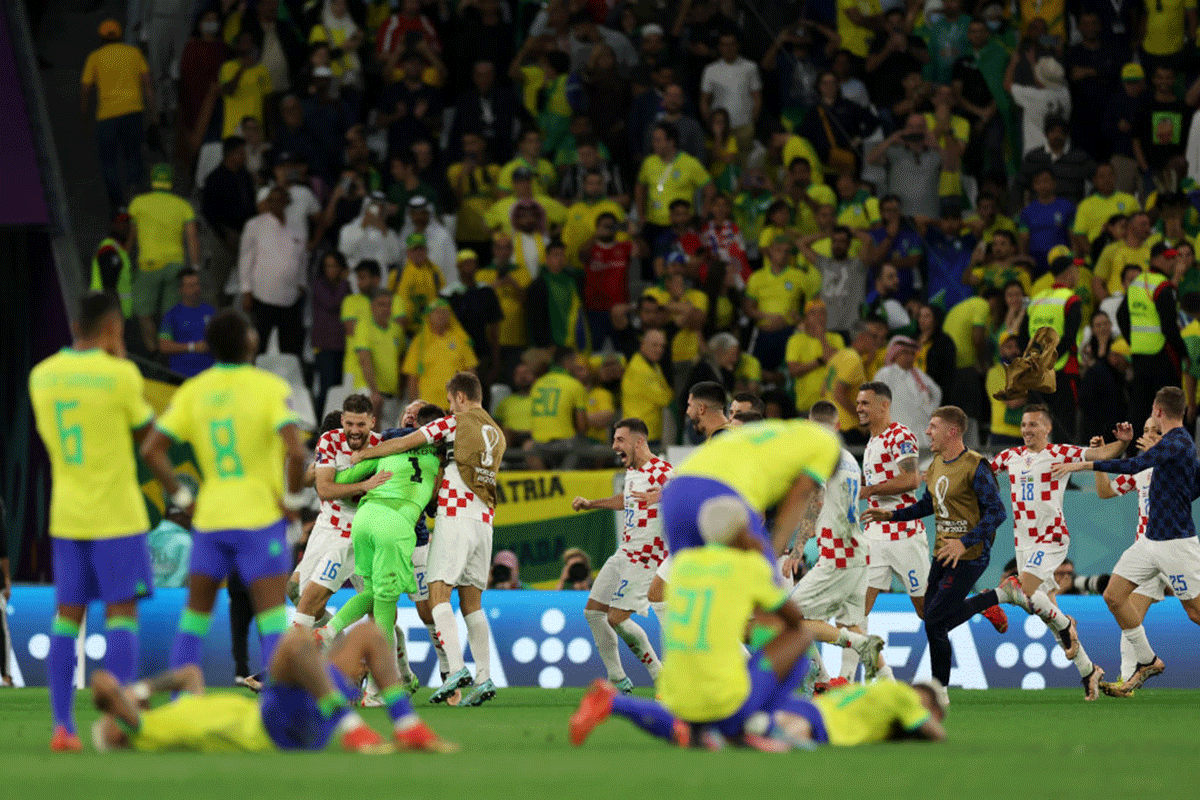 Croatia's Dominik Livakovic celebrates after Marquinhos of Brazil (not pictured) hits the post and misses the deciding penalty.