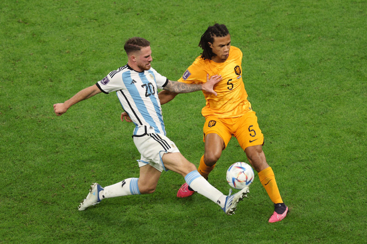 Argentina's Alexis Mac Allister battles for possession with The Netherlands' Nathan Ake