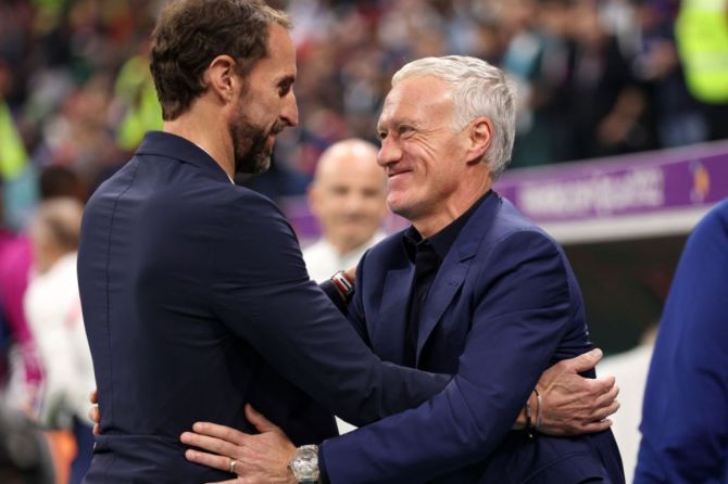  England Head Coach, Gareth Southgate embraces France Head Coach Didier Deschamps prior to the FIFA World Cup Qatar 2022 quarter final match between England and France