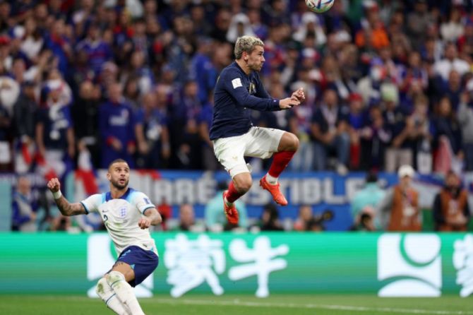 France's Antoine Griezmann heads the ball