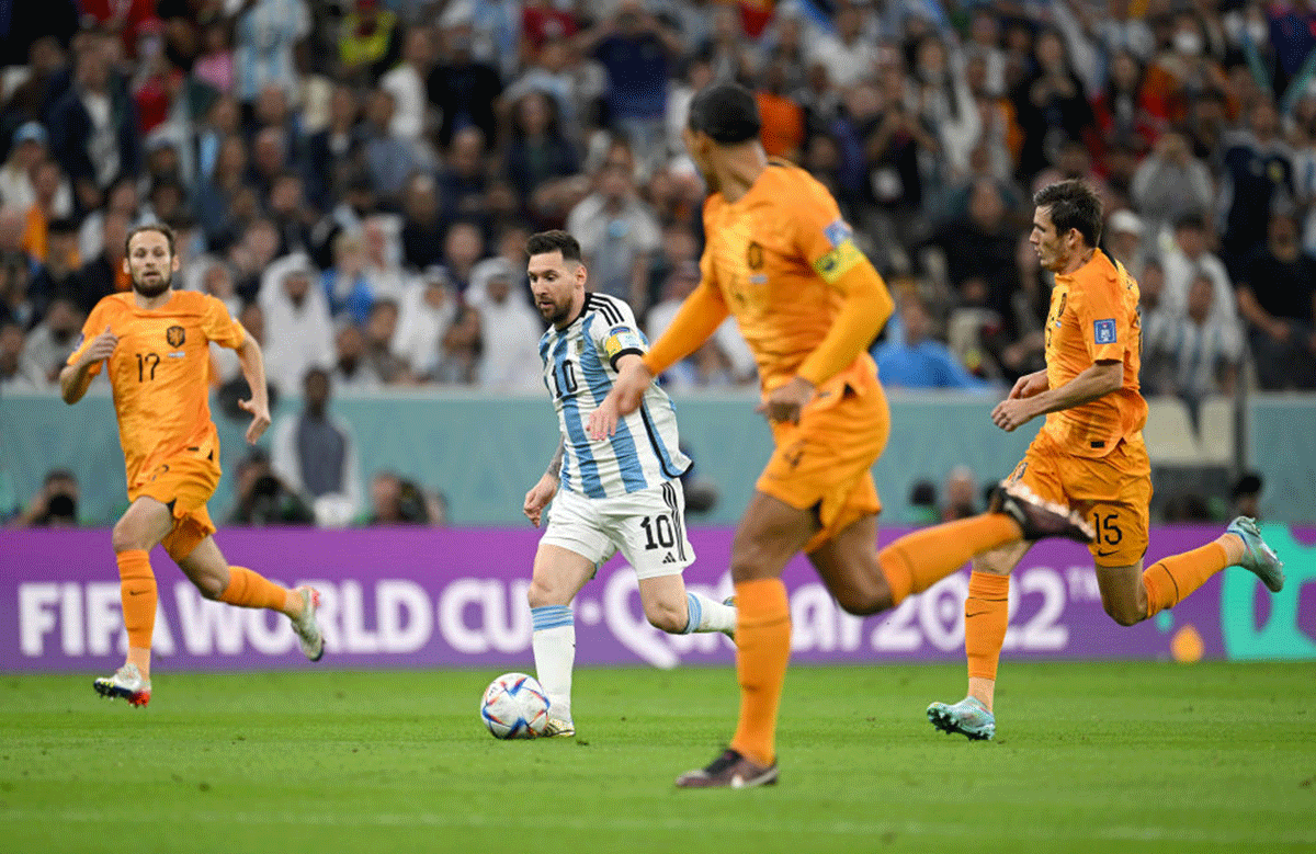 Lionel Messi makes his way past three Netherlands defenders. 