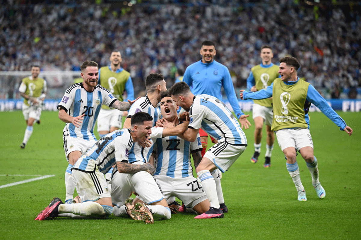 Argentina players celebrate with Lautaro Martinez after their win in the penalty shootout