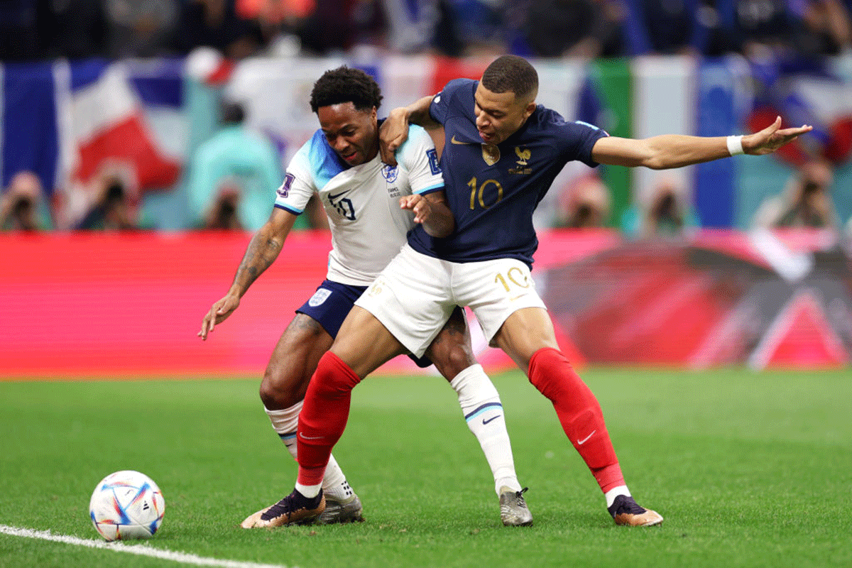 England's Raheem Sterling France's Kylian Mbappe of France compete for the ball