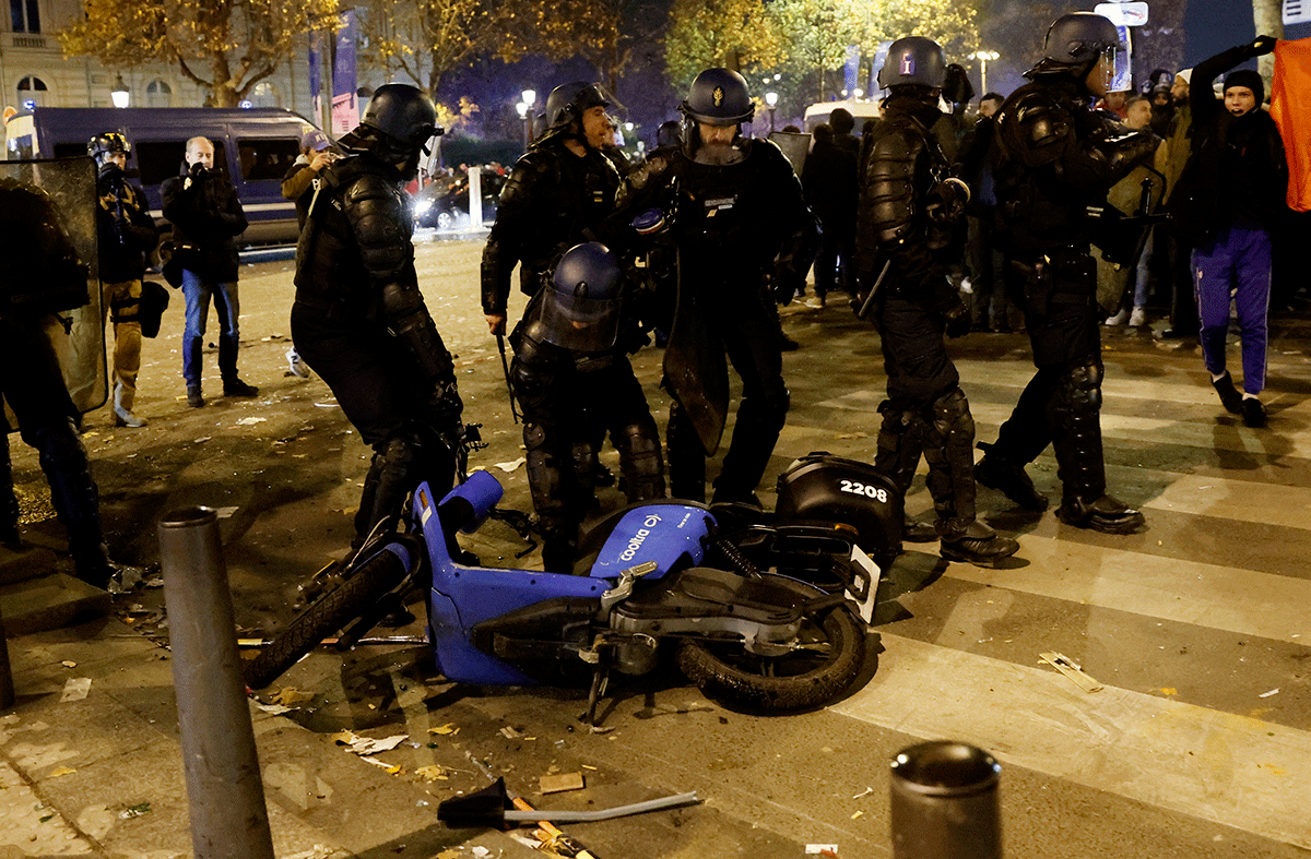 Police officers are seen near a motorbike during the Morocco fans celebrations after their win over Portugal on Sunday