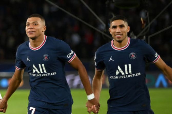 Kylian Mbappe and Achraf Hakimi of Paris Saint-Germain celebrate after victory in the UEFA Champions League