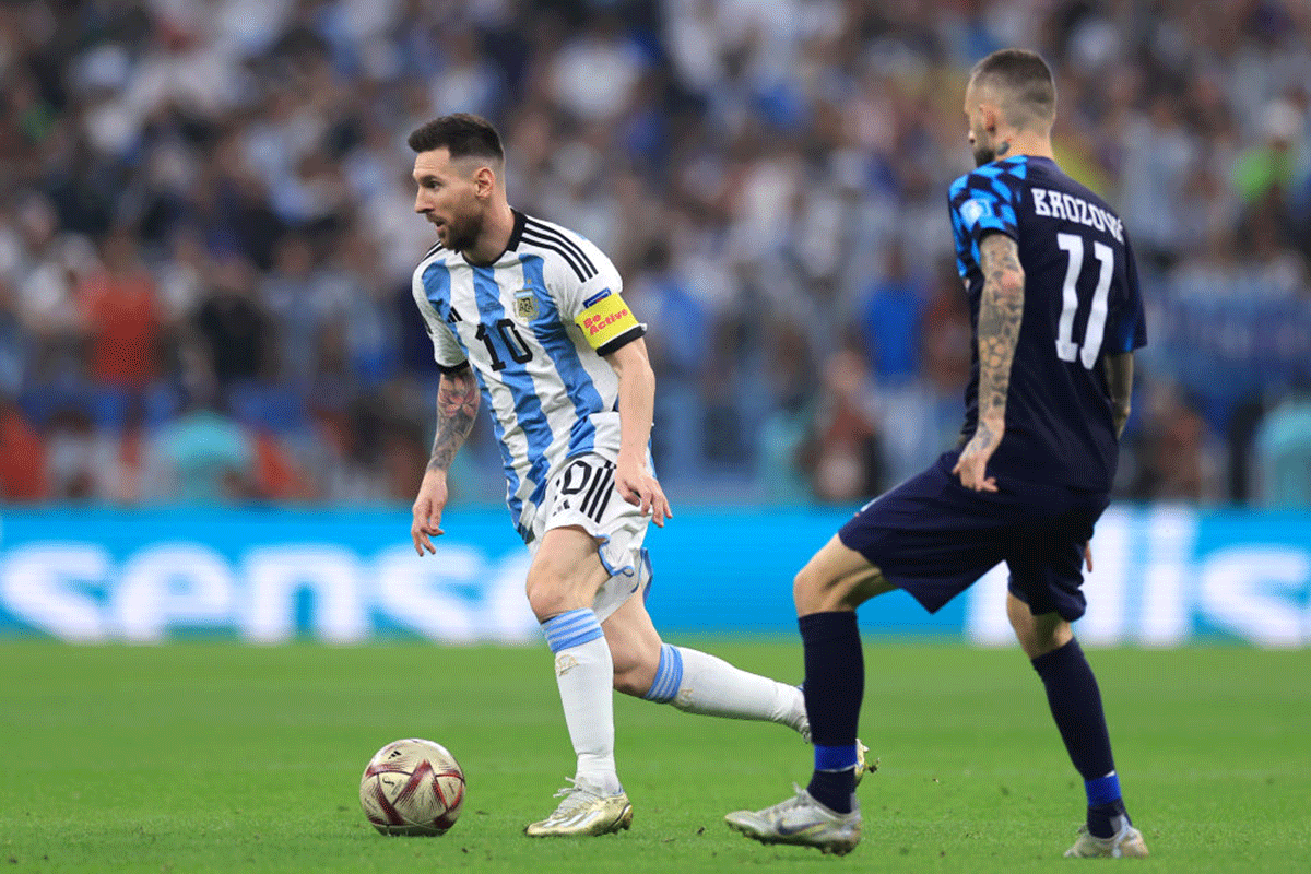 Argentina's Lionel Messi runs past an opposition player