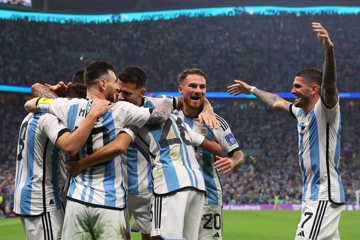 Argentina's Lionel Messi celebrates with teammates after scoring their first goal from the penalty spot