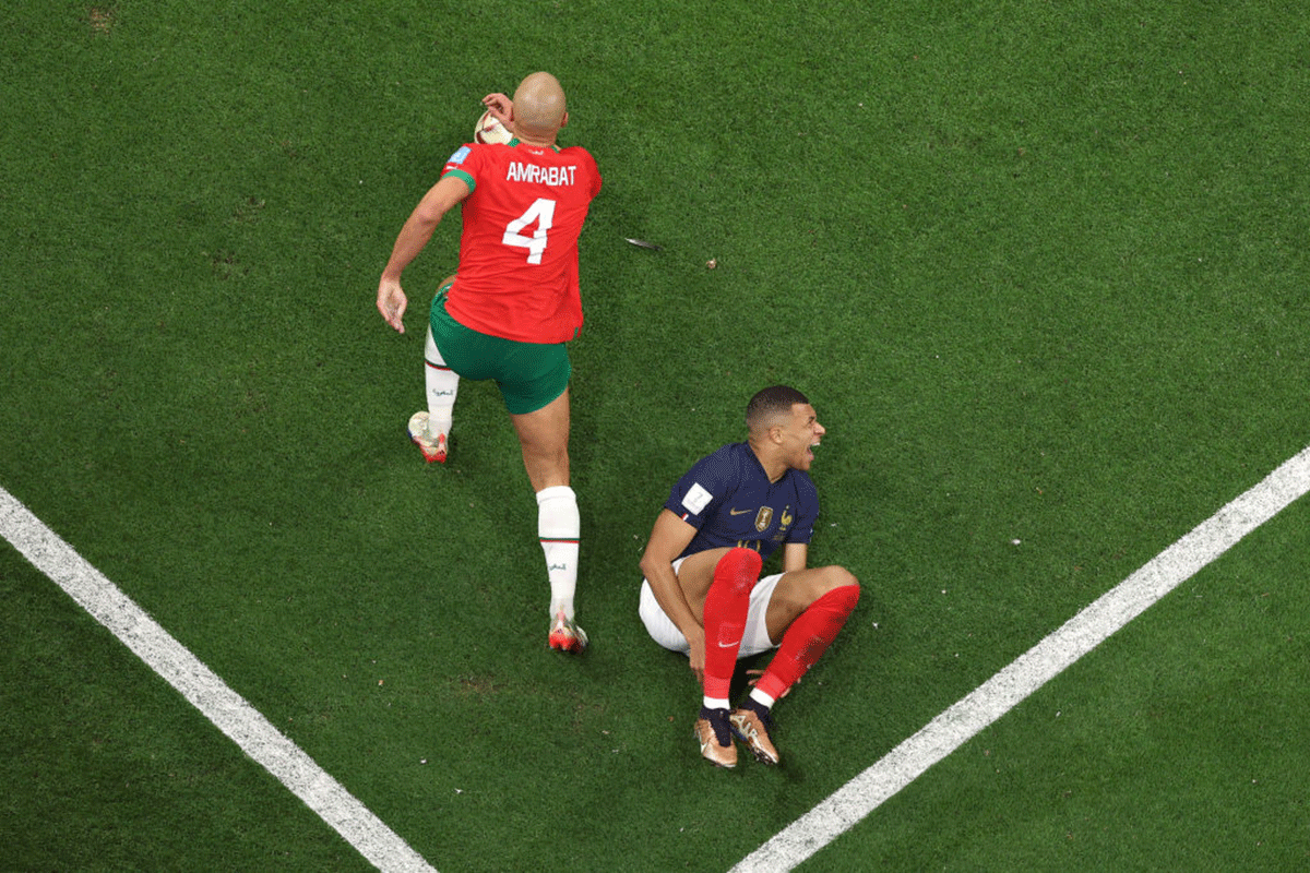 France's Kylian Mbappe is tackled by Morocco's Sofyan Amrabat