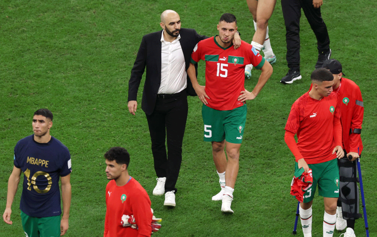 Head Coach of Morocco, Walid Regragui, embraces Selim Amallah after their 0-2 loss