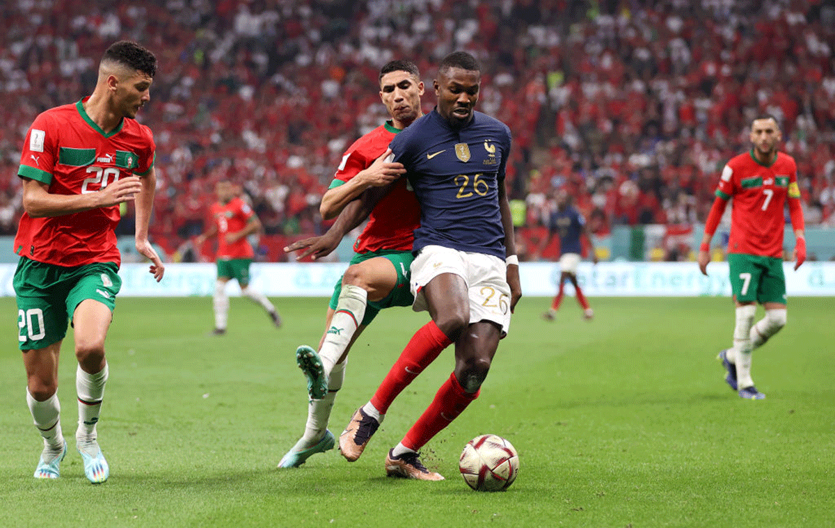 France's Marcus Thuram is challenged by Morocco's Achraf Hakimi