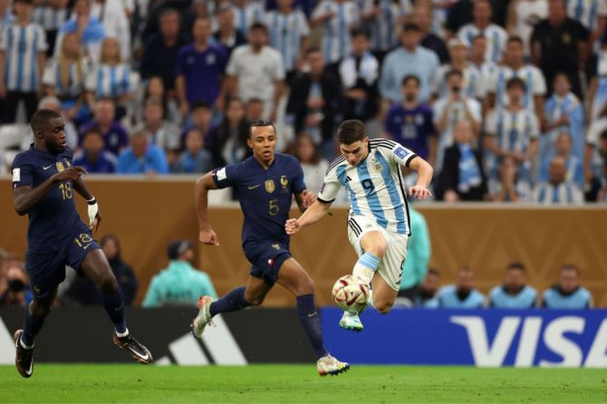  Argentina's Julian Alvarez controls the ball against France's Dayot Upamecano and Jules Kounde