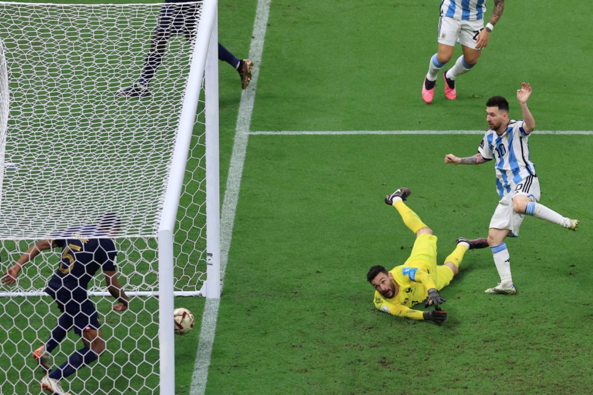  Lionel Messi of Argentina scores the team's third goal past Hugo Lloris of France as Jules Kounde attempts to clear