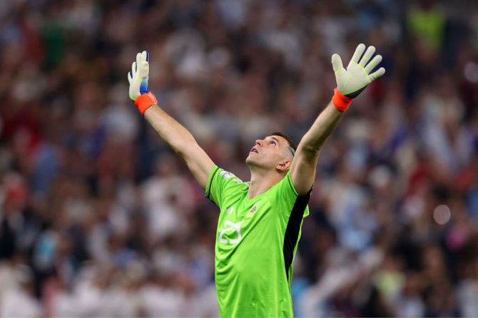 Emiliano Martinez of Argentina celebrates the team's first goal scored by Lionel Messi (not pictured)