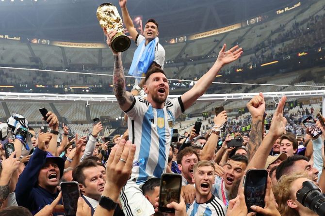 Argentina's Messi celebrates with the World Cup after the award ceremony