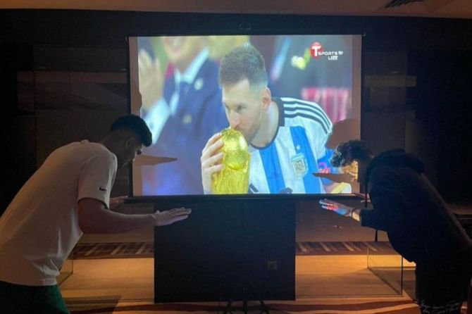 Shubman Gill bowing to the tv with Messi's pic on it