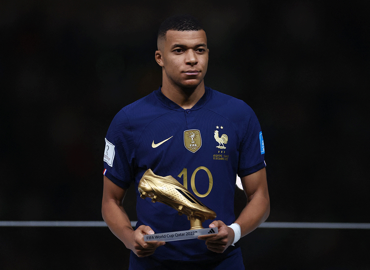 France's Kylian Mbappe poses with his Golden Boot award during the award ceremony after the match 