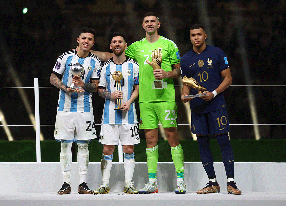 Best Young Player winner Argentina's Enzo Fernandez, Golden Ball winner Argentina's Lionel Messi, Golden Glove winner Argentina's Emiliano Martinez and Golden Boot winner France's Kylian Mbappe pose with their respective trophies