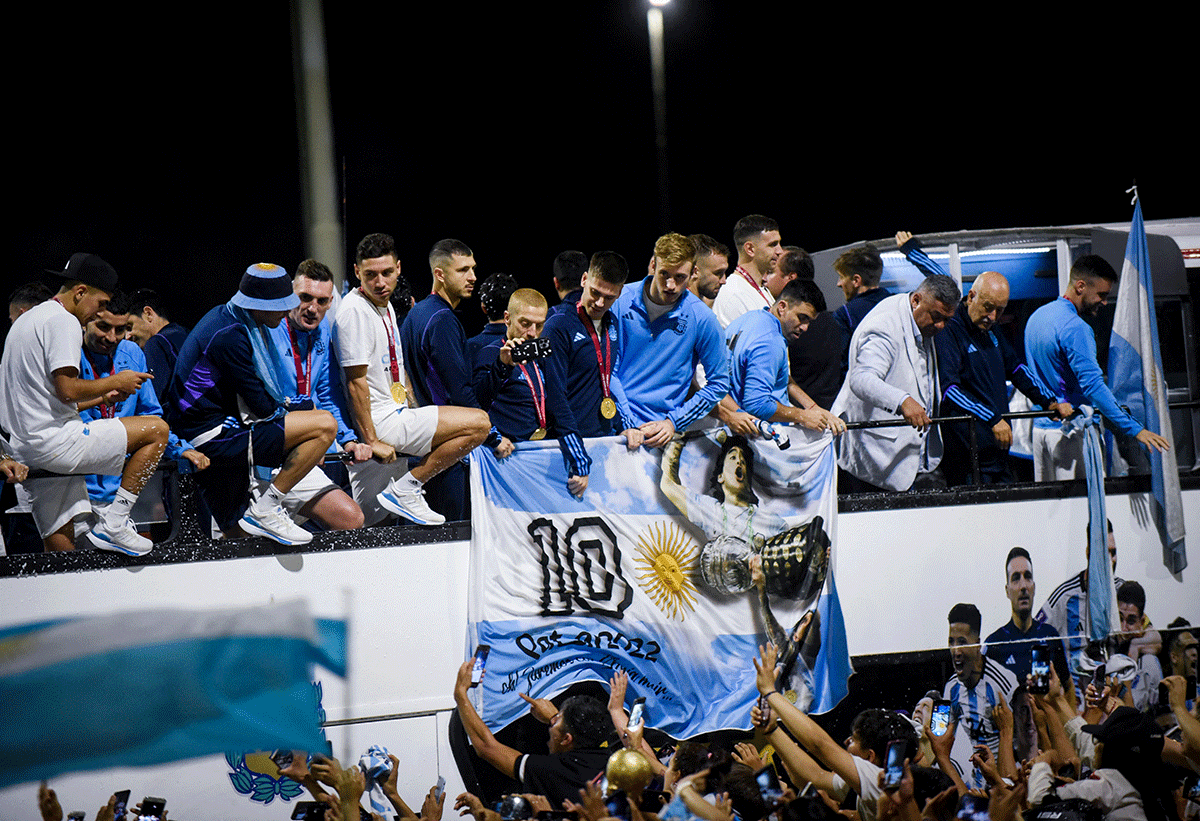 Claudio Tapia, president of the Argentine Football Association, is seen with the players on the open top bus as it arrives outside the Association of Argentinian Football headquarters.