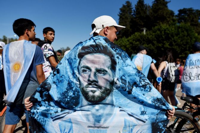  An Argentina fan displays a flag of Lionel Messi ahead of the victory parade