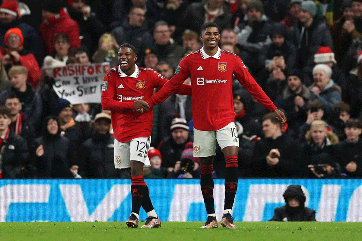 Manchester United's Marcus Rashford celebrates scoring their side's second goal with teammate Tyrell Malacia during the League Cup Carabao Cup Fourth Round match at Old Trafford in Manchester on Wednesday