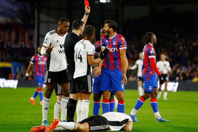  Crystal Palace's James Tomkins is shown a red card by referee Andrew Madley