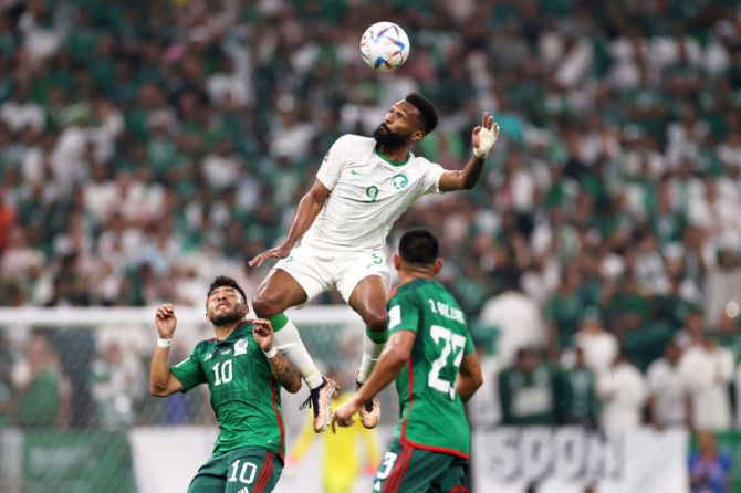 Feras Albrikan of Saudi Arabia jumps for the ball with Alexis Vega of Mexico