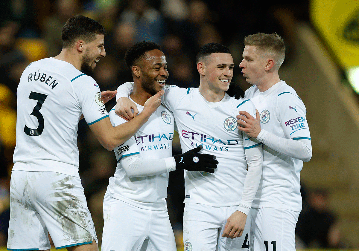 Manchester City's Raheem Sterling celebrates with teammates on scoring their third goal against Norwich City at Carrow Road, in Norwich 