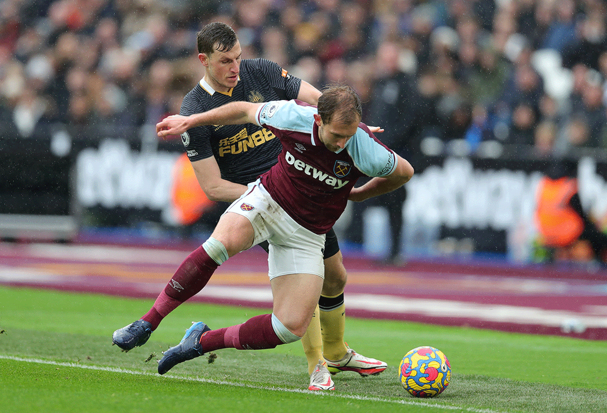 West Ham United's Craig Dawson and Newcastle United's Chris Wood vie for possession during their match at London Stadium, London, on Saturday 