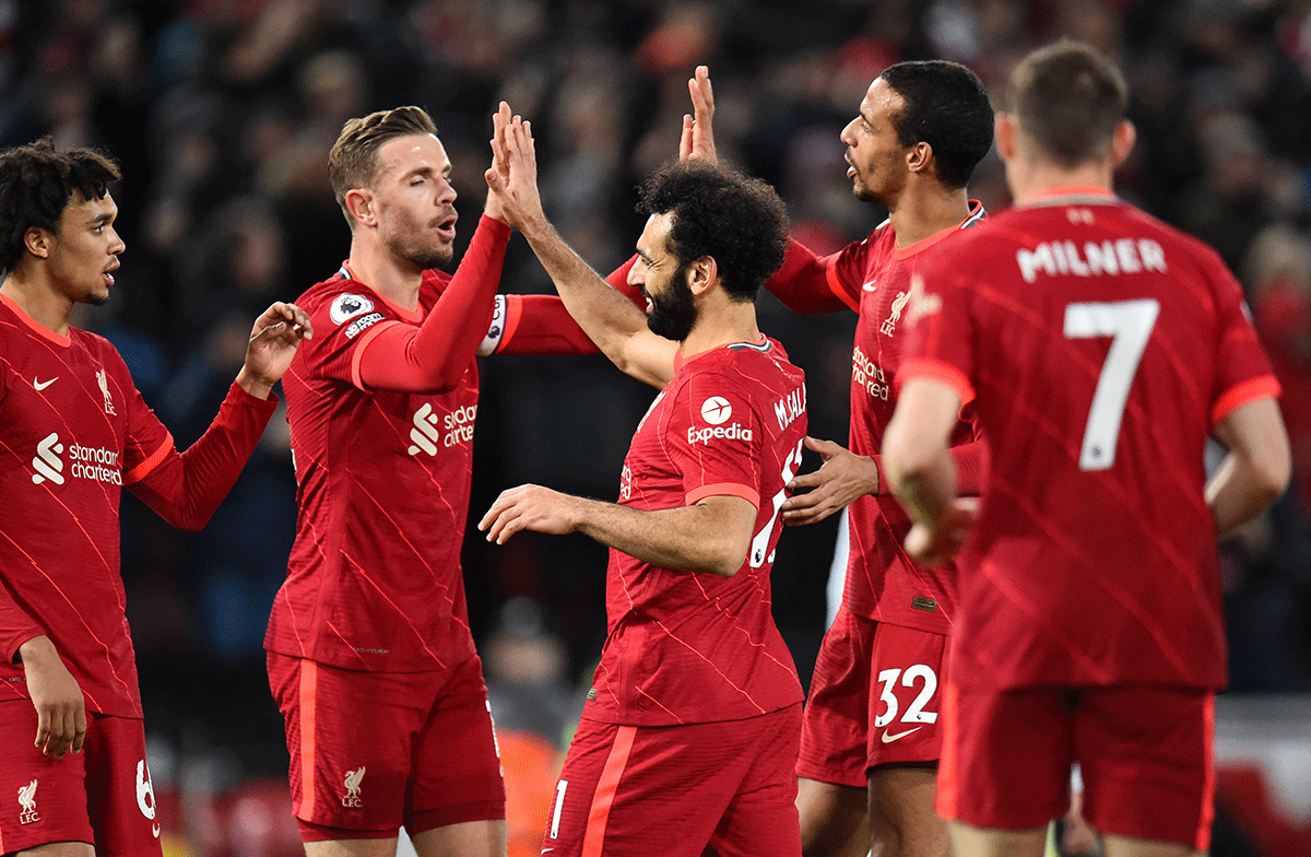 Liverpool's Jordan Henderson and Mohamed Salah celebrate after Sadio Mane scores their fourth goal against Leeds United at Anfield 