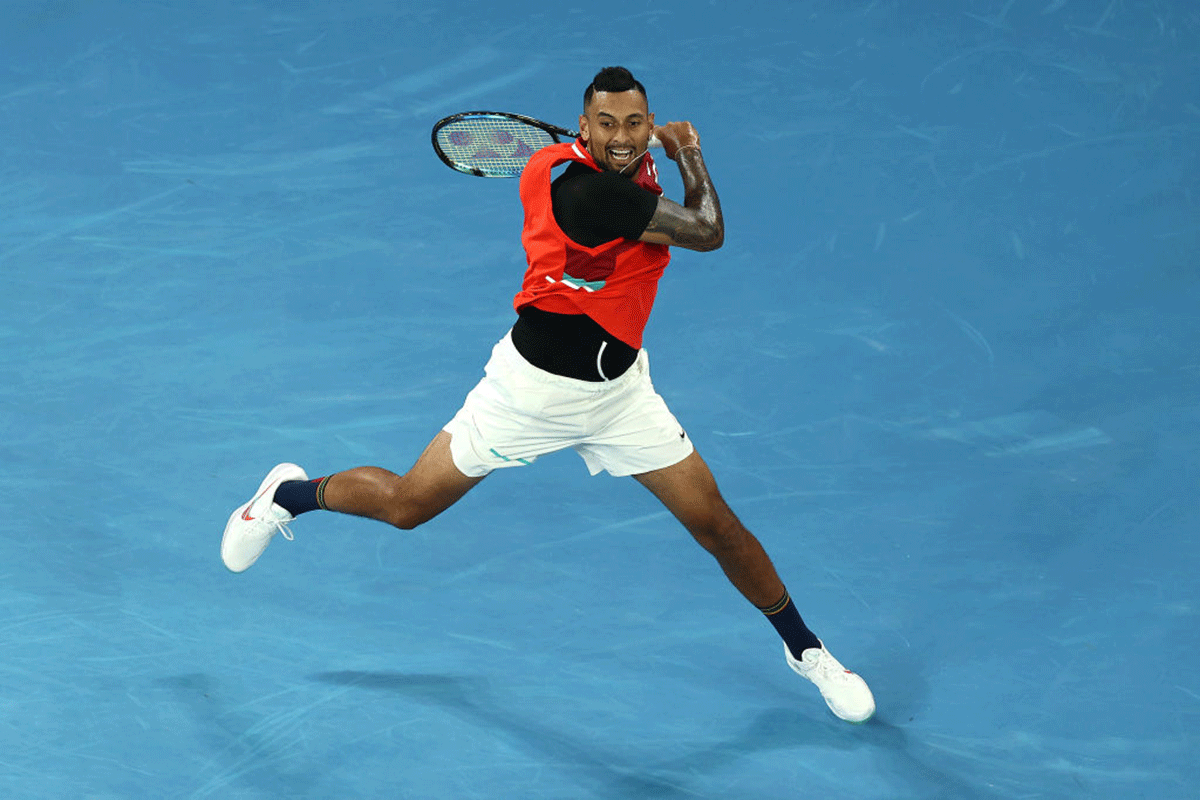 Nick Kyrgios plays a forehand return in his first round match against Liam Broady
