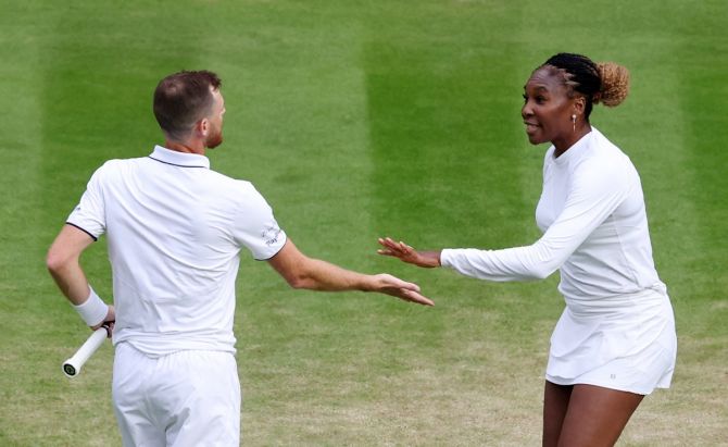 Jamie Murray and Venus Williams celebrate winning a point during their first round mixed doubles match.