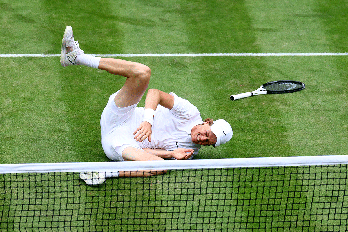 Italy's Jannik Sinner falls during his quarter-final against Serbia's Novak Djokovic