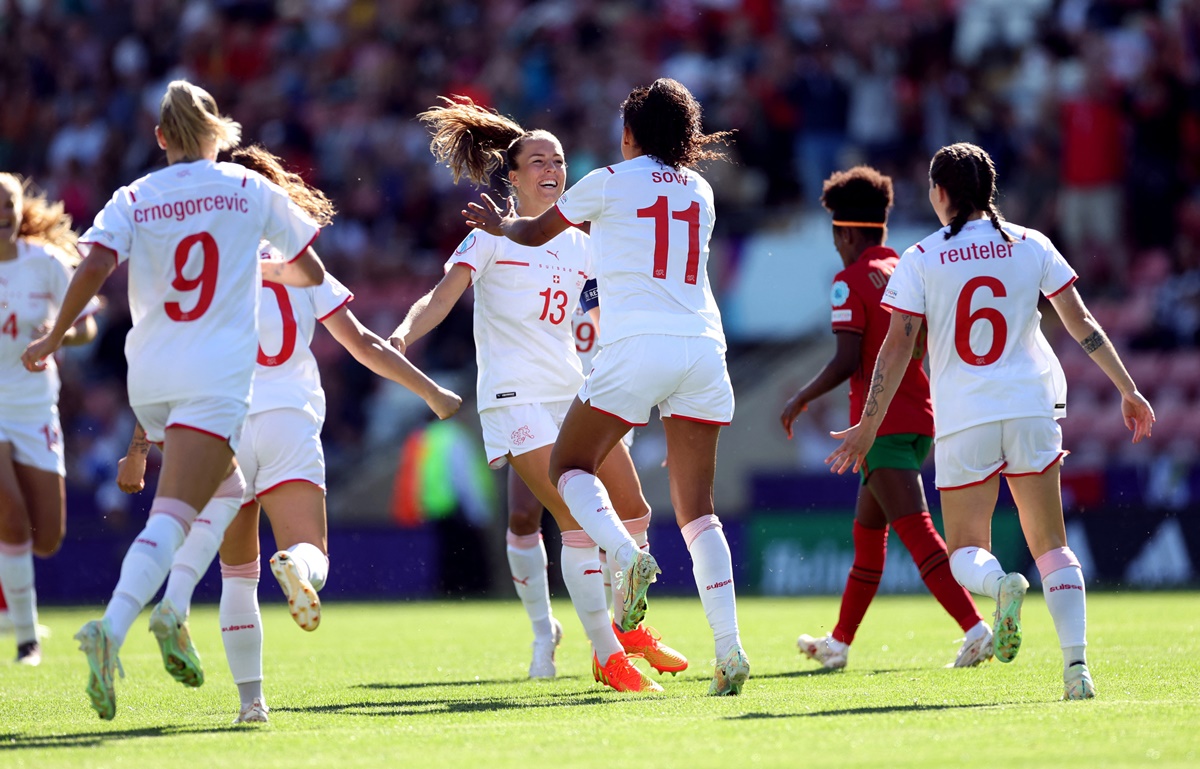 Coumba Sow celebrates with teammates after scoring Switzerland's first goal.