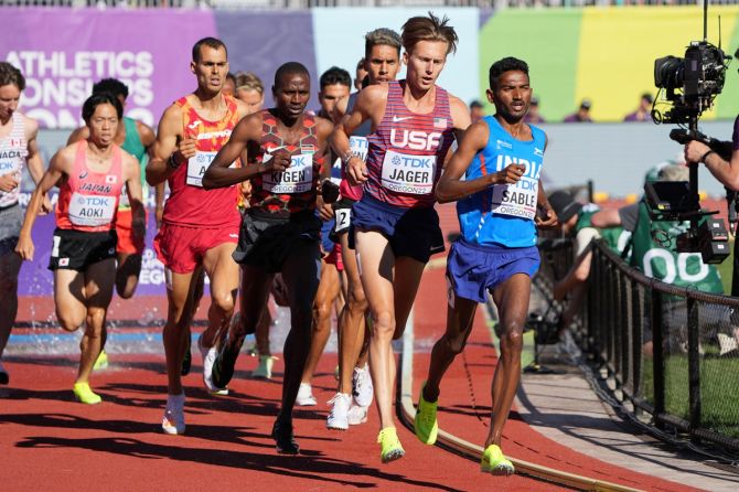 Kenya's Benjamin Kigen, Evan Jager of the United States and India's Avinash Mukund Sable lead the field in the third heat of the men's 3000 metres steeplechase at the World Athletics Championships